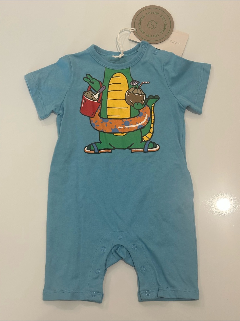 Stella McCartney Six Months Blue Dinosaur Graphic One-Piece Bodysuit